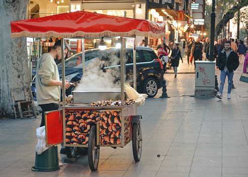 Istanbul, Turkey - May 02, 2023: Seller of roasted chestnuts and corn on the street in Istanbul