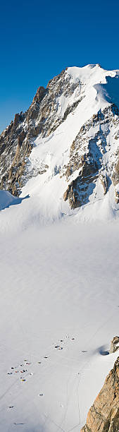 Base camp white mountain Clear, deep blue skies over the snow capped summit of Mont Blanc, the highest mountain in Europe, overlooking the cluster of climbers camping in the white wilderness of the Vall leisure activity french culture sport high angle view stock pictures, royalty-free photos & images