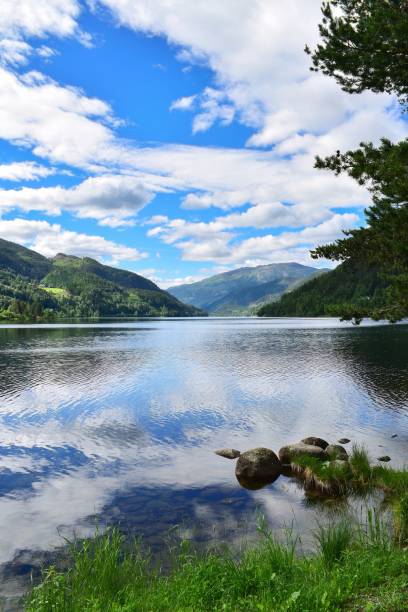 istock Clouds reflecting in lake surrounded by mountains. Norway landscape 1489631090