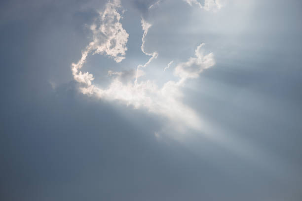istock Dramatic Sky and Sun Rays Background. Sunbeams Light and Moody Cloudscape. Sunbeam through the haze in cloudy day. 1489633371