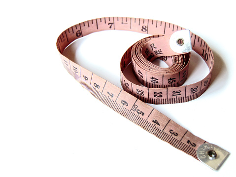 Fashion tool: A pink measuring tape with a white background. This soft tape measure is for taking body measurements, drafting patterns, measuring fabrics, laying out patterns on fabric, specifying the length of garments, etc.