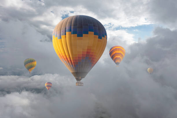 istock Colorful hot air balloon flying above the clouds. 1489639934