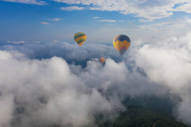 istock Colorful hot air balloon flying above the clouds. 1489642401