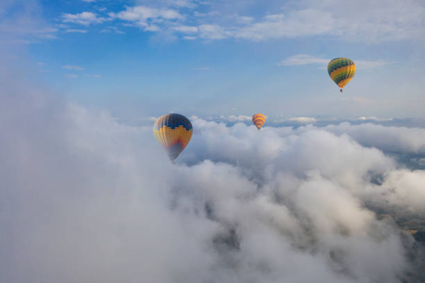 istock Colorful hot air balloon flying above the clouds. 1489643071