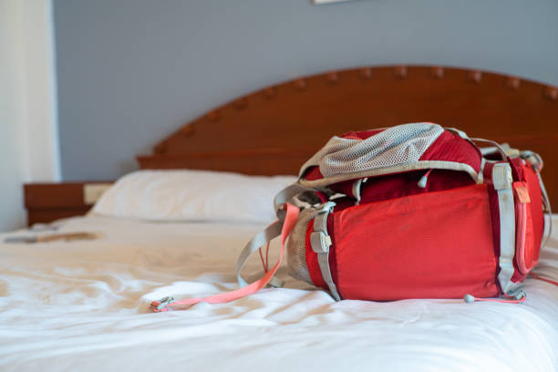 istock Red backpack on white bed in cozy resort 1489644777