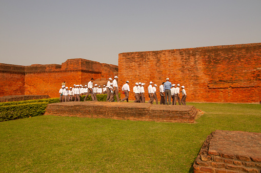 Bihar,India-March 28,2013 : Students visitting Nalanda University in Nilanda,bihar, India .Drew scholars from all over Asia, surviving for hundreds of years before being destroyed by invaders in 1193.