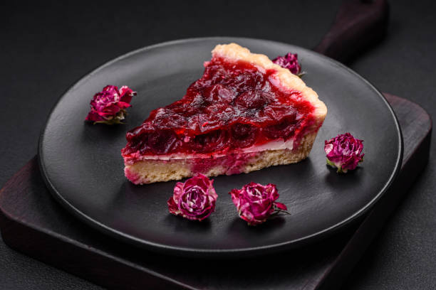 Delicious fragrant sweet pie with cherry berries on a ceramic plate