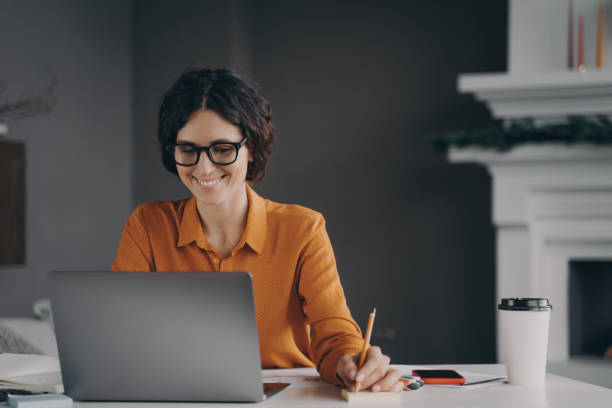 istock Pleasant happy young hispanic woman freelancer working on laptop computer at home 1489649697