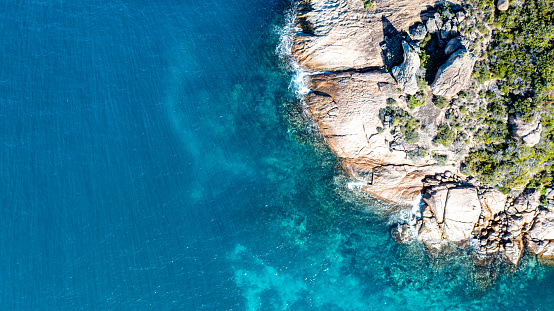Overhead photo of coast line with rocks and clear water near Lucky Bay in Western Australia