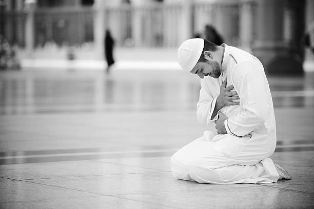 Muslim prayer at holy mosque stock photo