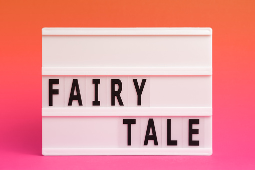 The word fairytale on lightbox isolated pink background. Literary Genres