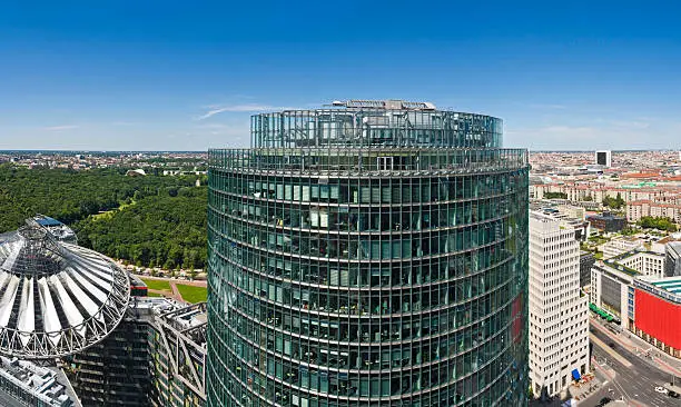 Clear summer skies over the leafy green oasis of the Tiergarten behind the ultra modern architecture of the redeveloped Potsdamer Platz in the heart of Berlin, Germany. ProPhoto RGB profile for maximum color fidelity and gamut.