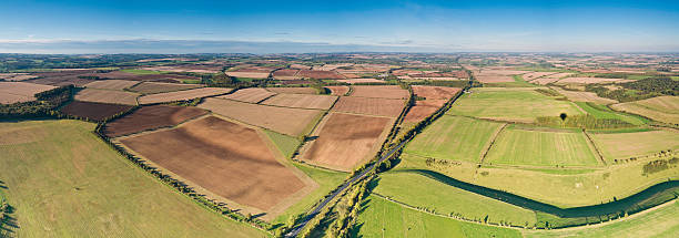 istock Summer farm patchwork land aerial panorama 148965538