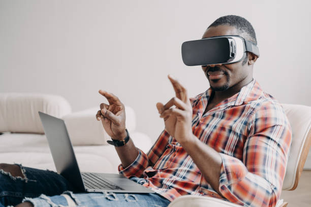 istock African american guy software delevoper in virtual reality glasses working in cyberspace at laptop 1489656161