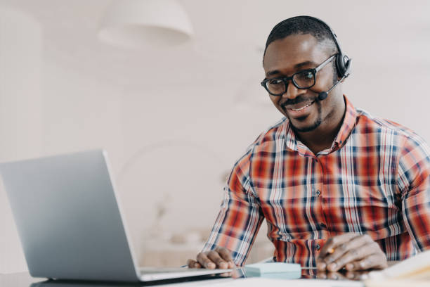 istock African american man support services technician in headset works at laptop communicates with client 1489656198