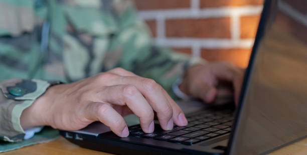 istock close up soldier man hand typing on keyboard laptop to check and use command for military operation test system in office room concept 1489657766