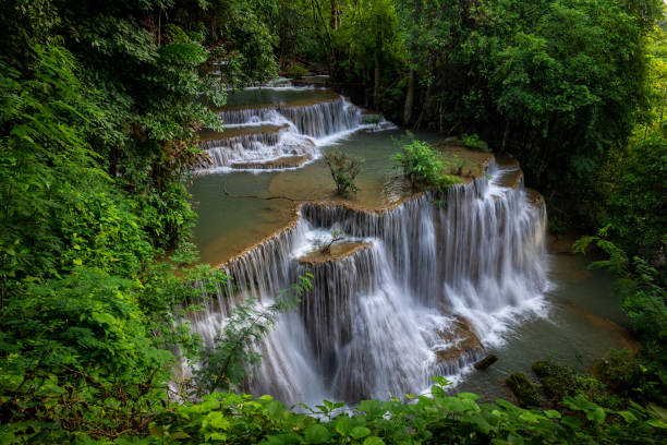 Hua Mea Khamin Waterfall have tropical trees, ferns, growth up on waterfall in the morning light, cool, fresh weather and quiet place to relaxation in jungle. karnchanaburi, Thailand.