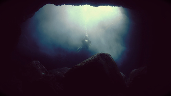 Underwater photo from a scuba dive in a cave with mysterious sunlight