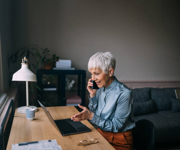 istock A Happy Beautiful Businesswoman Working From Home Using Her Computer And Her Mobile Phone 1489663309