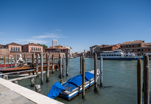 Venice, Italy - April 27, 2023: High resolution. Canal in the island of Murano, surrounded by beautiful old buildings. Murano is famous for its production of Venetian glass.