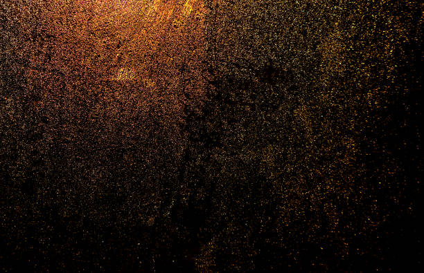 istock Black dark orange red brown shiny glitter abstract background with space. Twinkling glow stars effect. Like outer space, night sky, universe. Rusty, rough surface, grain. 1489666821