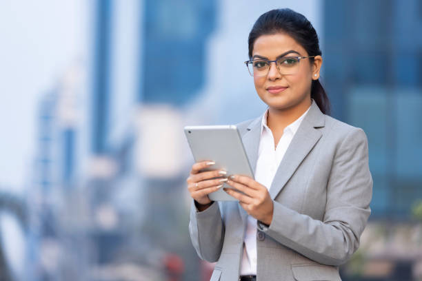 istock Businesswoman using digital tablet outside office building 1489668579