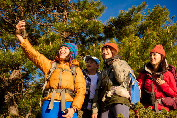 istock Friends with backpack taking selfie portrait on a mountain. 1489668888