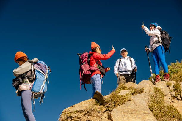 istock Friends with backpack taking selfie portrait on a mountain. 1489669263