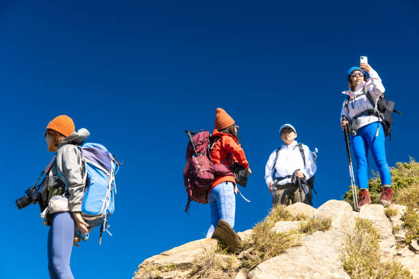 istock Friends with backpack taking selfie portrait on a mountain. 1489669544