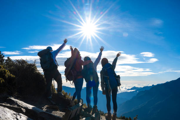 istock Hikers stand on top of a mountain looking at view. 1489670411