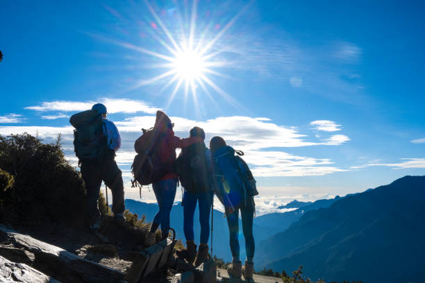 istock Hikers stand on top of a mountain looking at view. 1489670444