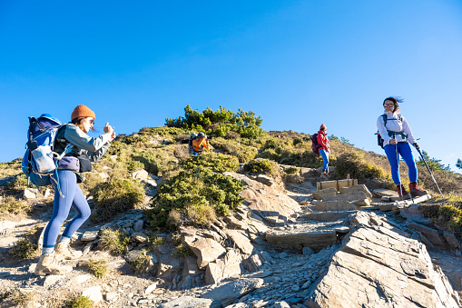 Hikers walking alone on top of a mountain.