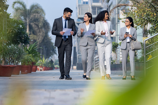 Business colleagues discussion outside office building.