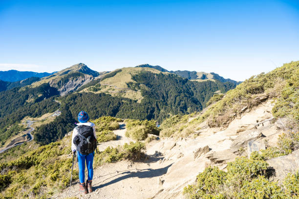 istock Hikers walking alone on top of a mountain. 1489681522