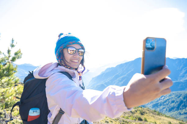 istock Friends with backpack taking selfie portrait on a mountain. 1489681624