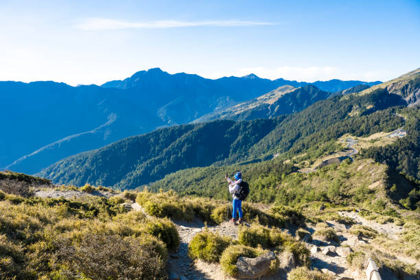 istock Mountain hiker taking photos on the mountain top. 1489683411