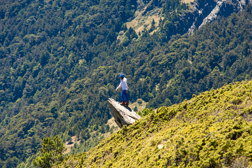 Hiker on the top of the mountain peak.