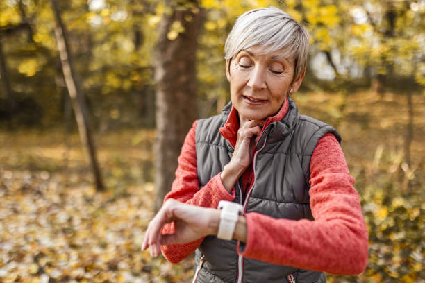 istock Senior woman in park taking break taking pulse 1489695674