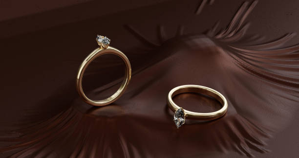 istock 3d render of gold ring with diamonds onon maroon fabric background. 1489696917