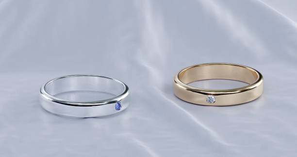 istock 3D Rendering of a gold and platinum engagement ring in studio lighting on white fabric background. 1489696979