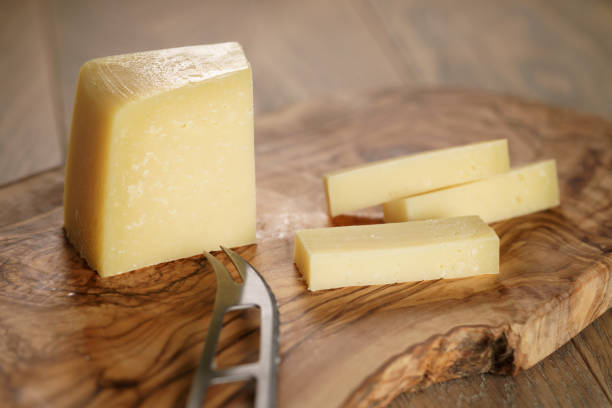 istock cutted parmesan cheese on olive cutting board 1489701003