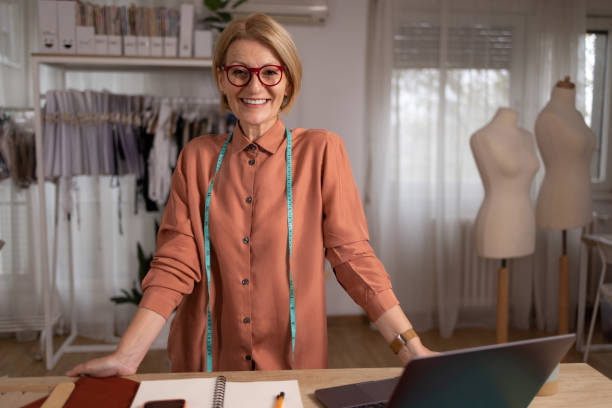 istock Happy female tailor working in a clothing design studio. 1489702254
