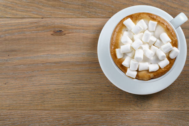 istock cup of cappuccino with marshmallow on table 1489708686