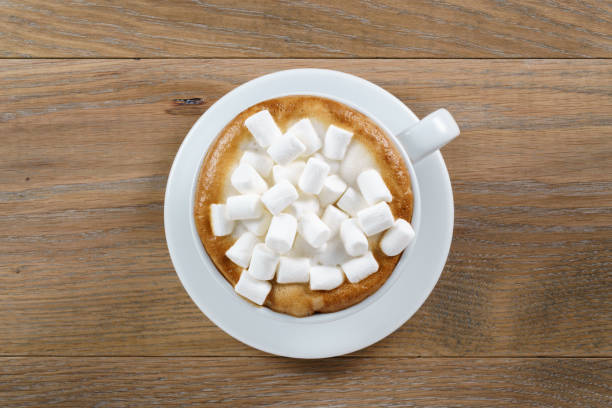 istock cup of cappuccino with marshmallow on table 1489708723