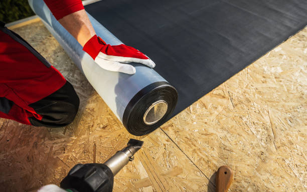 Roof Worker with Roll of EPDM Rubber Membrane stock photo