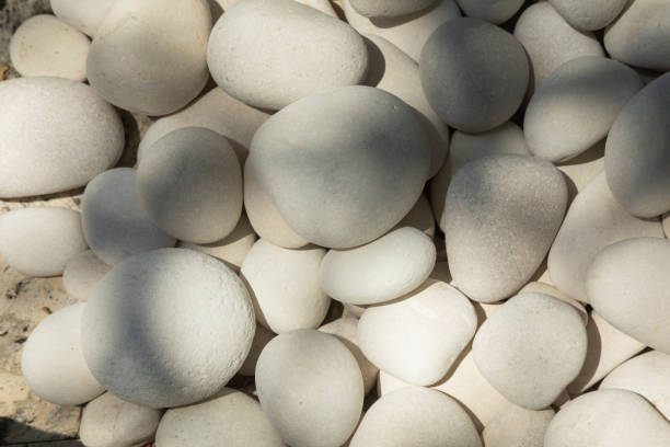istock Closeup high angle view of smooth white pebbles 1489714201