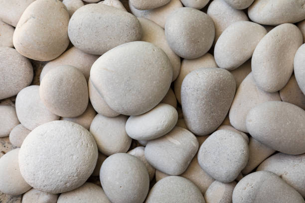 Closeup high angle view of smooth white pebbles stock photo