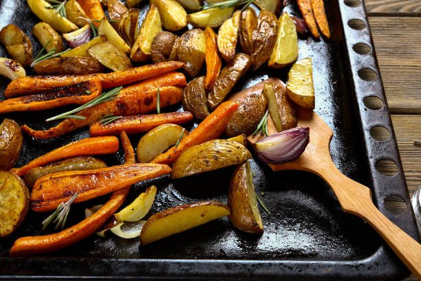 istock Potatoes with carrots, onions on a baking tray vegan 1489722380