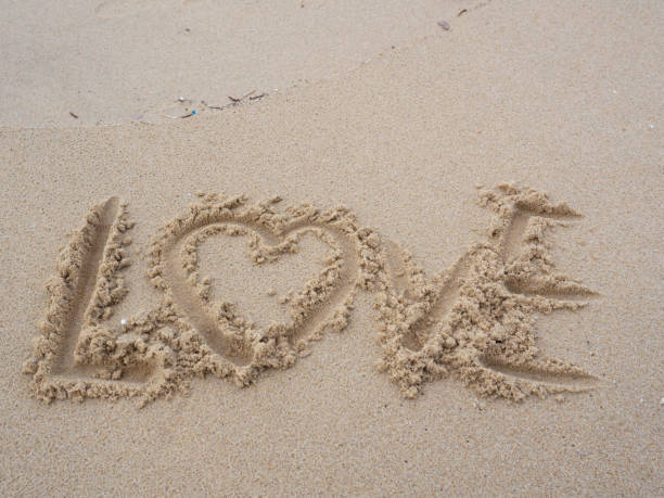 istock Word love in the sand at the beach. 1489723101