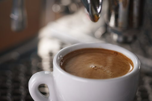 closeup photo of prepared espresso coffee from coffee machine, shallow focus
